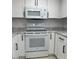 Updated kitchen featuring white cabinets, modern appliances, stainless steel sink, and tile flooring at 225 N Pomeroy -- # 16, Mesa, AZ 85201