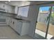 Updated kitchen featuring white cabinets, modern appliances, stainless steel sink, and tile flooring at 225 N Pomeroy -- # 16, Mesa, AZ 85201