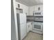 Updated kitchen featuring white cabinets, modern appliances, stainless steel sink, and tile flooring at 225 N Pomeroy -- # 16, Mesa, AZ 85201