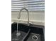 Close-up of a modern sink and faucet with water running, set against a window at 225 N Pomeroy -- # 16, Mesa, AZ 85201