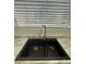 A modern kitchen sink beneath a window with natural light and stylish blinds at 225 N Pomeroy -- # 16, Mesa, AZ 85201