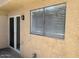 A cozy patio area with sliding glass doors and a window featuring horizontal blinds, perfect for outdoor relaxation at 225 N Pomeroy -- # 16, Mesa, AZ 85201