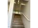 Bright stairway featuring wood steps, white walls, and a white handrail at 225 N Pomeroy -- # 16, Mesa, AZ 85201