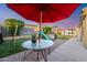 Inviting backyard featuring a playset, green lawn, and covered patio area perfect for outdoor gatherings at 23932 W Hidalgo Ave, Buckeye, AZ 85326