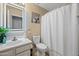 Clean bathroom features a modern vanity, mirror, and a shower with a white curtain at 23932 W Hidalgo Ave, Buckeye, AZ 85326