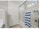 Well-lit bathroom featuring a glass-enclosed shower and a door, offering a clean and functional space at 23932 W Hidalgo Ave, Buckeye, AZ 85326