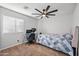 Cozy bedroom with a ceiling fan, desk, and comfortable decor for a relaxing atmosphere at 23932 W Hidalgo Ave, Buckeye, AZ 85326