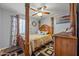 Bedroom with a four-poster bed, ceiling fan, and warm, inviting decor at 23932 W Hidalgo Ave, Buckeye, AZ 85326
