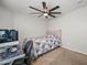 Inviting bedroom with a ceiling fan, desk setup, and a comfortable atmosphere for study or relaxation at 23932 W Hidalgo Ave, Buckeye, AZ 85326