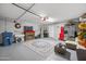 Organized garage space with painted floors, tv, fireplace and ample room for parking and storage at 23932 W Hidalgo Ave, Buckeye, AZ 85326