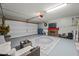 Well-maintained garage with painted floor, tv, fireplace, and room for seating at 23932 W Hidalgo Ave, Buckeye, AZ 85326