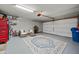 Clean garage with an organized storage area, painted floor, and plenty of space for parking vehicles at 23932 W Hidalgo Ave, Buckeye, AZ 85326