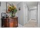 Hallway with art and decorations, with a side table and wood flooring at 23932 W Hidalgo Ave, Buckeye, AZ 85326