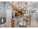 Well-lit kitchen with stainless steel appliances, stone countertops and a breakfast bar at 23932 W Hidalgo Ave, Buckeye, AZ 85326