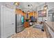 Well-lit kitchen with stainless steel appliances, stone countertops and a double basin sink at 23932 W Hidalgo Ave, Buckeye, AZ 85326