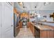 Well-lit kitchen with stainless steel appliances, stone countertops, and wood flooring at 23932 W Hidalgo Ave, Buckeye, AZ 85326