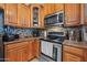 Close up of the kitchen with stainless steel appliances, tile backsplash and stone countertops at 23932 W Hidalgo Ave, Buckeye, AZ 85326