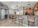 Open concept kitchen with a breakfast bar looking out towards the dining room and living room at 23932 W Hidalgo Ave, Buckeye, AZ 85326
