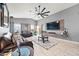 Living room with a ceiling fan, tile flooring, television and gray walls at 23932 W Hidalgo Ave, Buckeye, AZ 85326