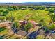 Aerial view of park showing soccer field and playground equipment surrounded by walking paths and lush trees at 24066 N 167Th Ln, Surprise, AZ 85387