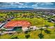 Aerial view showcasing the baseball field, lush green surroundings, and scenic mountain backdrop at 24066 N 167Th Ln, Surprise, AZ 85387