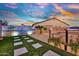 Backyard oasis featuring artificial turf, a sparkling pool, and a decorative fence for privacy at 24066 N 167Th Ln, Surprise, AZ 85387