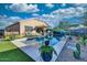 Backyard showcases a sparkling swimming pool with a baja shelf, desert landscaping, and patio space perfect for entertaining at 24066 N 167Th Ln, Surprise, AZ 85387