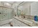 Bright bathroom with granite countertops, dual sinks, decorative mirrors and a glass shower door at 24066 N 167Th Ln, Surprise, AZ 85387