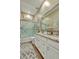 Bright bathroom with granite countertops, dual sinks, decorative mirrors and a glass shower door at 24066 N 167Th Ln, Surprise, AZ 85387
