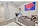 This modern bedroom showcases a bed with flower-patterned duvet and a study area with shelves at 24066 N 167Th Ln, Surprise, AZ 85387