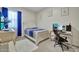 This stylish bedroom boasts blue accents, a comfortable bed, and a computer desk setup at 24066 N 167Th Ln, Surprise, AZ 85387
