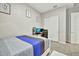 This simple bedroom has a bed with a tri-color quilt, a study desk, and a closet at 24066 N 167Th Ln, Surprise, AZ 85387