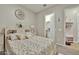 Comfortable bedroom featuring a decorative headboard, soft carpet, and access to a walk-in closet at 24066 N 167Th Ln, Surprise, AZ 85387