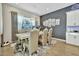 Elegant dining room with modern lighting, a large window, and stylish decor at 24066 N 167Th Ln, Surprise, AZ 85387
