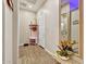 Inviting entryway features wood-look tile, storage bench, and a decorative mirror, providing a warm welcome at 24066 N 167Th Ln, Surprise, AZ 85387