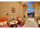 Inviting front porch with chairs, decor and desert plants creates a cozy and welcoming entryway to the home at 24066 N 167Th Ln, Surprise, AZ 85387