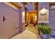 Inviting front porch featuring a cozy sitting area and lush potted plants for a warm welcome at 24066 N 167Th Ln, Surprise, AZ 85387