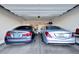Spacious two-car garage with ample storage space and two cars parked inside at 24066 N 167Th Ln, Surprise, AZ 85387