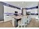 Bright, open kitchen with a large island, granite countertops, pendant lighting, and seating for four at 24066 N 167Th Ln, Surprise, AZ 85387