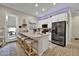 This modern kitchen includes an island with barstool seating, white cabinets, and stainless appliances at 24066 N 167Th Ln, Surprise, AZ 85387