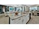 Kitchen island features granite countertop and cabinets with the living and dining rooms in the background at 24066 N 167Th Ln, Surprise, AZ 85387