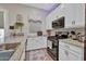 This gourmet kitchen is equipped with granite counters, white cabinetry, and black appliances at 24066 N 167Th Ln, Surprise, AZ 85387