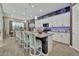 Open kitchen with an island, barstool seating, white cabinets, and modern appliances at 24066 N 167Th Ln, Surprise, AZ 85387