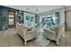Sophisticated living room with fireplace, TV, stylish furniture, and sliding glass doors leading to the pool at 24066 N 167Th Ln, Surprise, AZ 85387