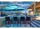 Outdoor kitchen featuring bar seating, a grill, and countertop space, perfect for entertaining around the pool at 24066 N 167Th Ln, Surprise, AZ 85387