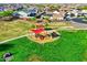 Community playground with a red canopy and slide, nestled in a well-maintained green space at 24066 N 167Th Ln, Surprise, AZ 85387
