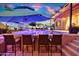 Outdoor bar with a view of the pool, desert mural, and comfortable outdoor seating area for perfect relaxation at 24066 N 167Th Ln, Surprise, AZ 85387