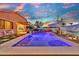 Sparkling pool with baja step, desert mural and outdoor seating offering a serene backyard retreat at 24066 N 167Th Ln, Surprise, AZ 85387