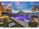Inviting pool area with desert-themed mural, cozy seating, and vibrant sunset creates a relaxing backyard oasis at 24066 N 167Th Ln, Surprise, AZ 85387
