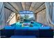 Luxurious outdoor lounge area with ample seating, overhead string lights, and views of the sparkling swimming pool at 24066 N 167Th Ln, Surprise, AZ 85387